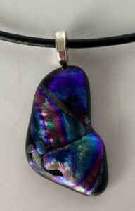 Modern shaped dichroic pendant with in beautiful blue, green, purple & gold design. Item number N62: 1 1/4" x 3/4" inches. Price: $20