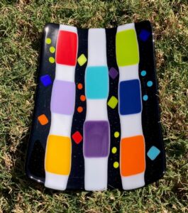 Fun plate with bright blocks and circles of color. Item number 199: 8 1/2" by 8 1/2". Price: $35 Item number 174: 10" by 6 1/2". Price: $45
