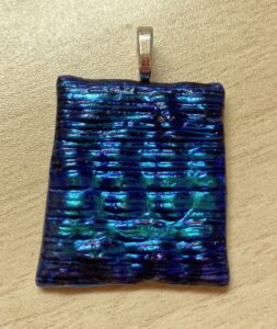 Dichroic pendant in beautiful purple and blue in a horizontal design. Item number N85: 1" x 1 1/4" inches. Price: $25