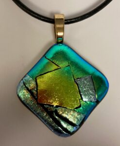 Modern shaped dichroic pendant with beautiful green & gold design. Item number N88: 1 1/4" x 1 1/4" inches. Price: $35
