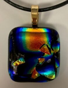 Gorgeous dichroic pendant with beautiful red, blue, green & gold design. Item number N89: 1" x 1" inches. Price: $35
