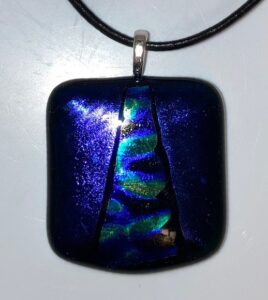 Purple and blue/green dichroic pendant in modern design. Item number N91: 1 1/4" x 1 1/4" inches. Price: $30