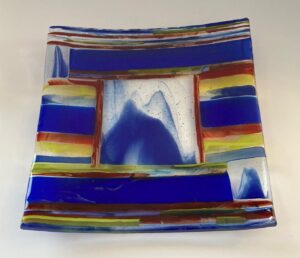 Beautiful blue, yellow and red on-edge statement piece with images of mountains. Number 221. 8" by 8". Price: $50