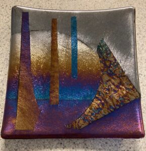 Modern irid pattern of blues, purples, silver and gold create a showpiece. Item number 222: 8" by 8". Price: $45