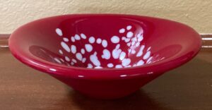 Cone shaped bowl with deep red and white dots. Item number 233: 6" oblong shape. Cost: $35.00